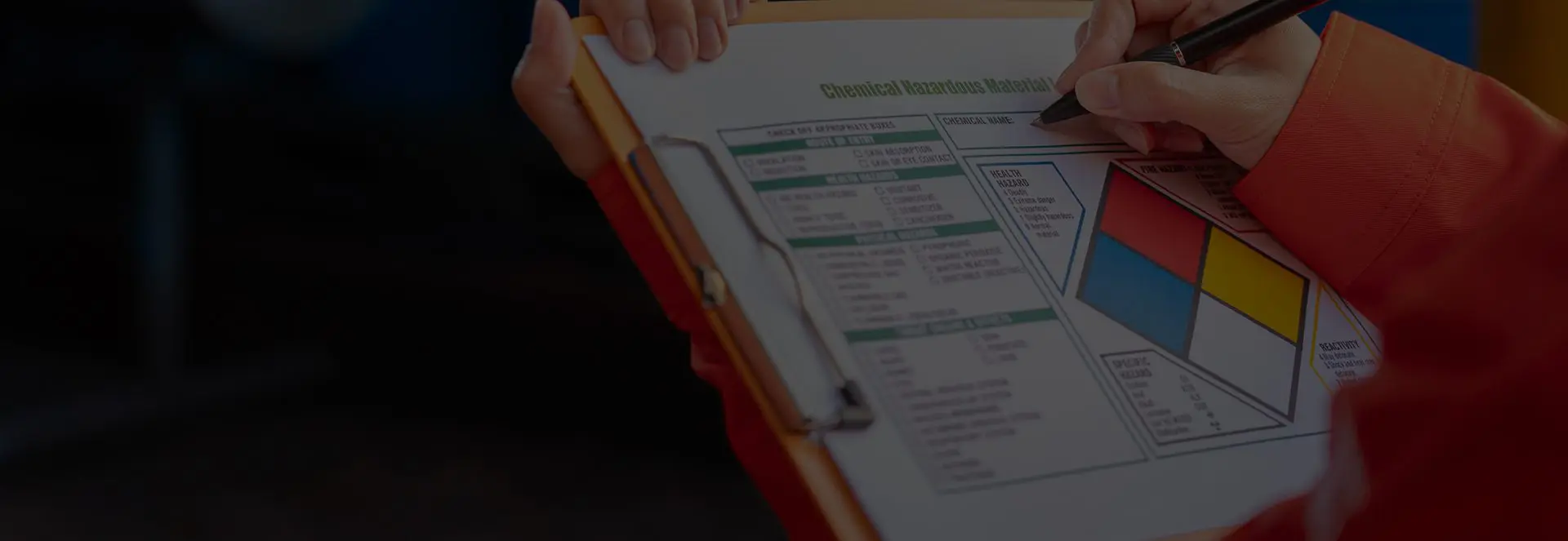 Person writing on a clipboard with chart.