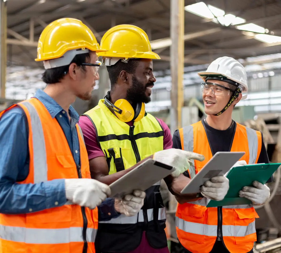 Construction workers discussing with safety gear.